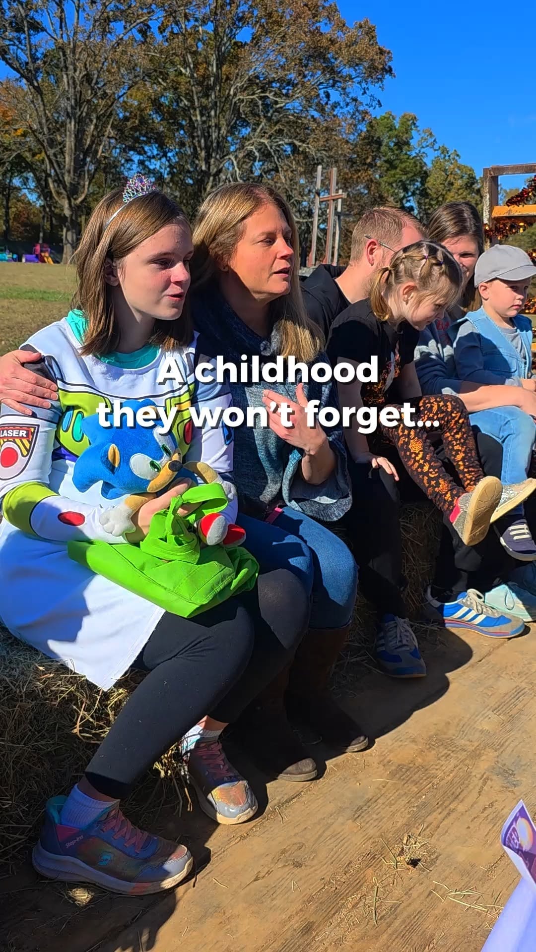 Children sitting with a teacher at an outdoor Learning Habitat event