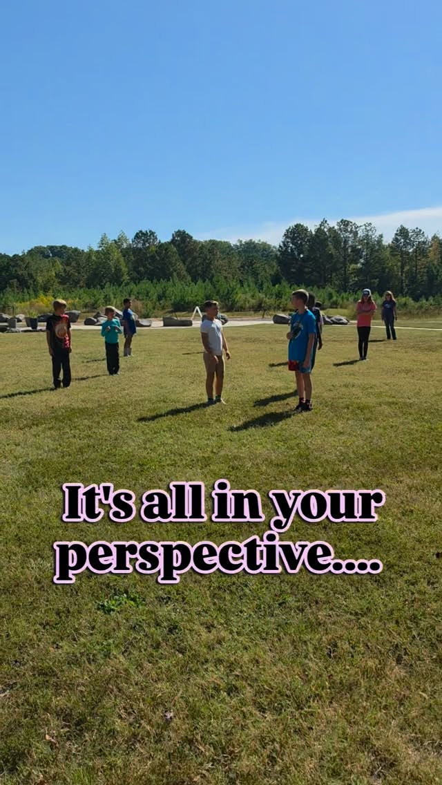 Students playing in a grassy field under the words: It's all in your perspective