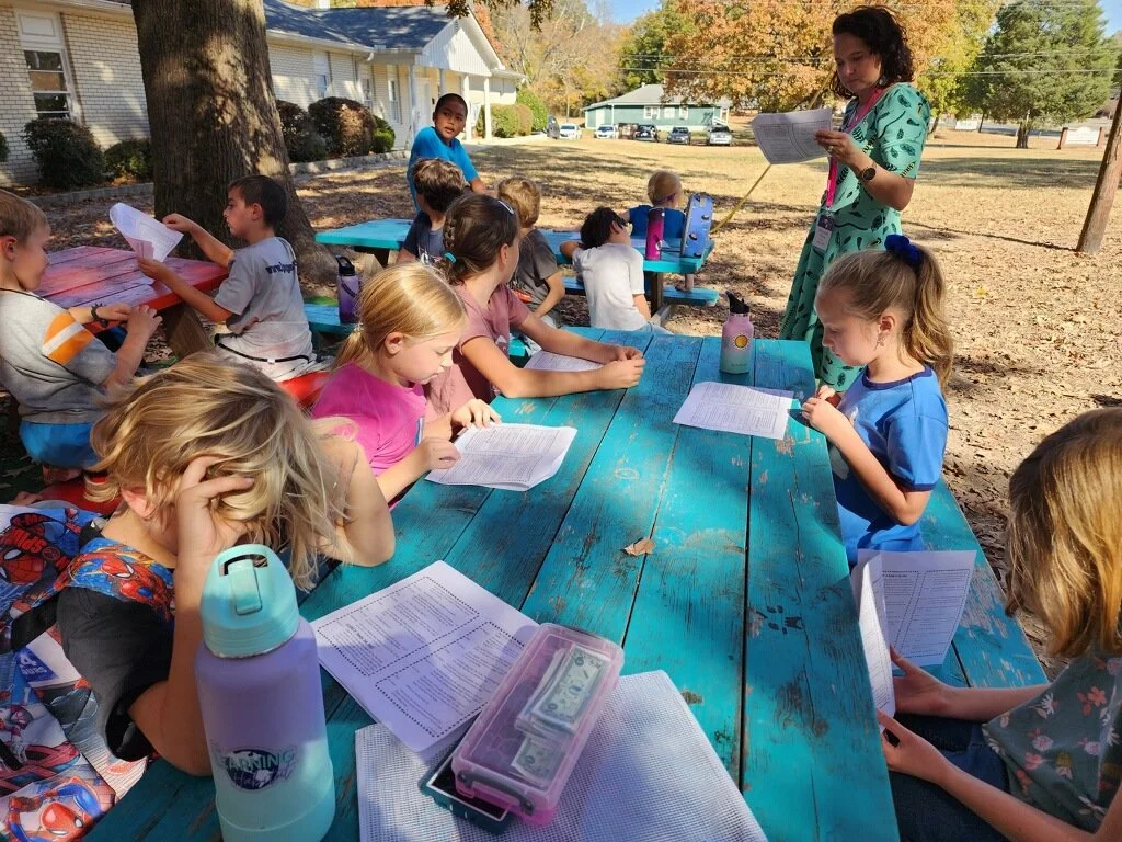 Children learning together outdoors at The Learning Habitat