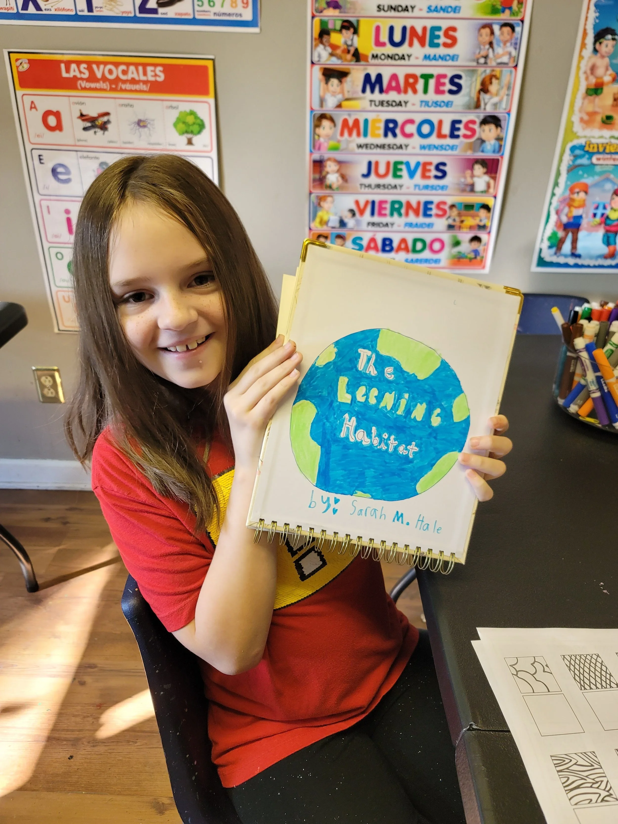 A student proudly displaying a learning project